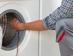 Dryer repair technician diagnosing and servicing a clothes dryer in Pasadena, CA