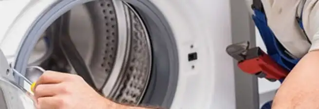 Appliance technician repairing a clothes dryer drum and internal parts in Pasadena, CA