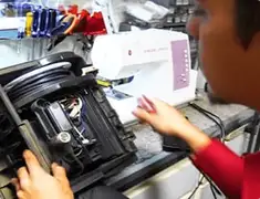 Vacuum repair technician servicing internal components on a workbench in Pasadena, CA